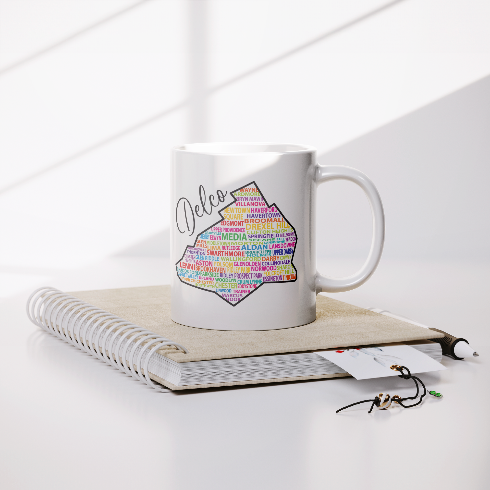 Delco_Towns_Mug_Lifestyle_Notebook_Mockup.png